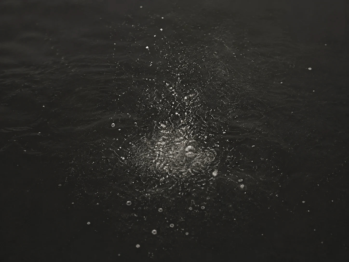 The object is absent; only sparse mineral residue remains in dark water.